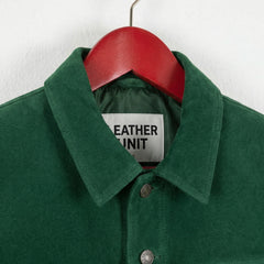 Close-up of collar and front snaps on men's green suede trucker jacket by Leather Unit