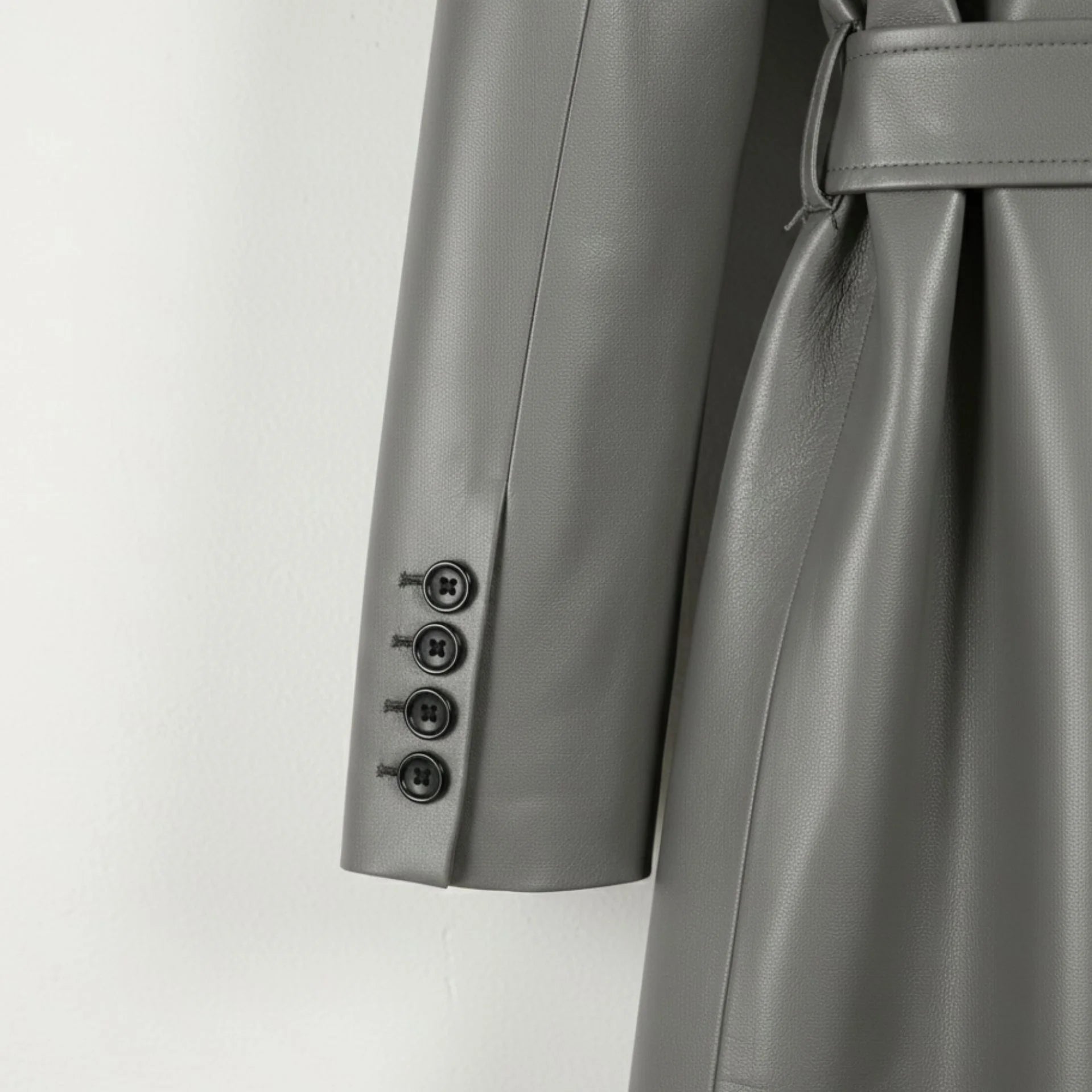 Sleeve cuff with four buttons on women’s grey leather trench coat