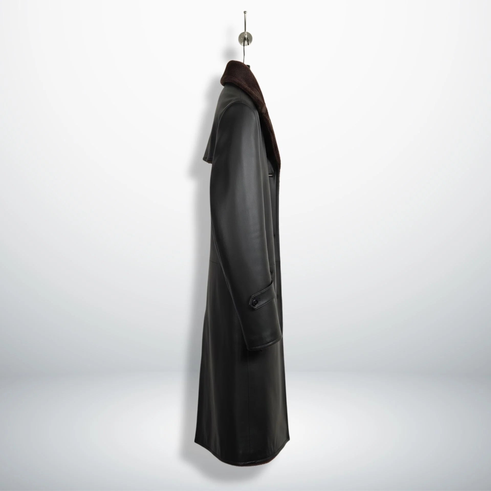 Side profile of men’s black shearling leather overcoat showing length
