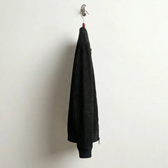 Side profile of men's slim fit black suede bomber jacket