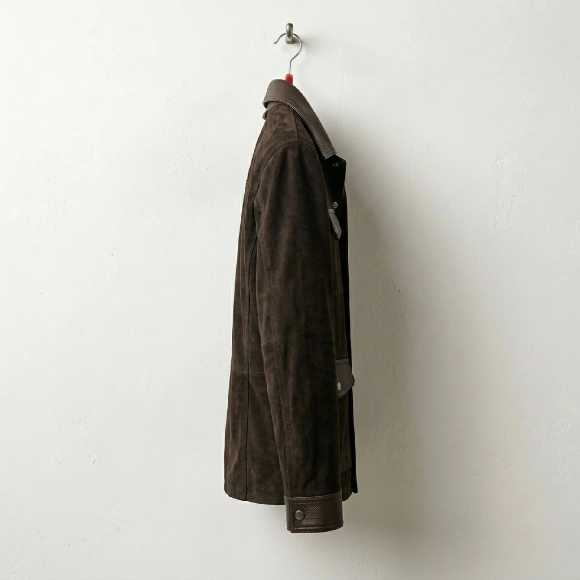 Side profile of men's brown suede trucker jacket with snap cuffs
