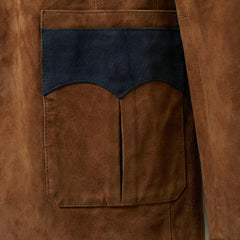 Close view of western style patch pocket with navy suede trim on blazer