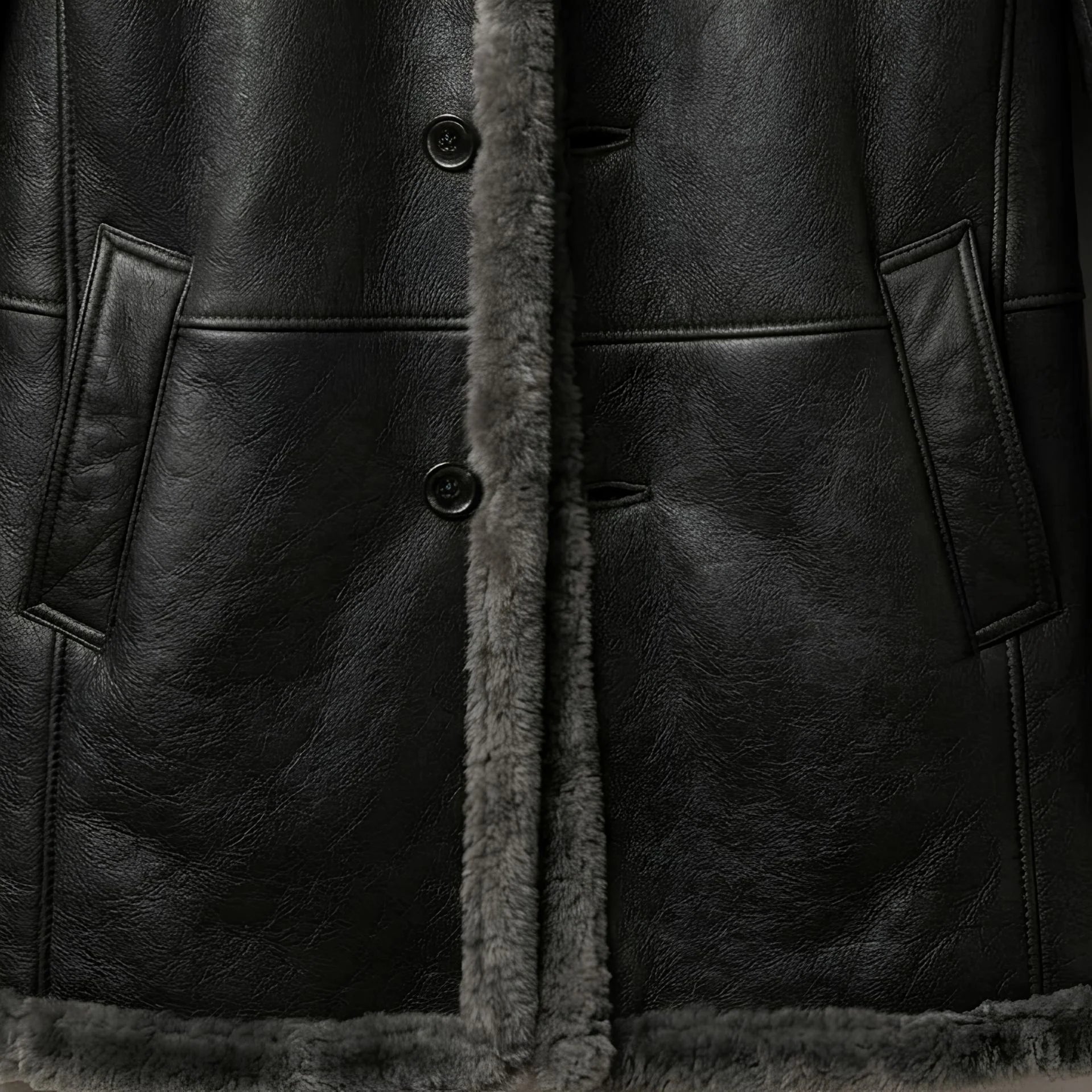 Button front and hand‑warmer pockets on men’s grey shearling leather coat