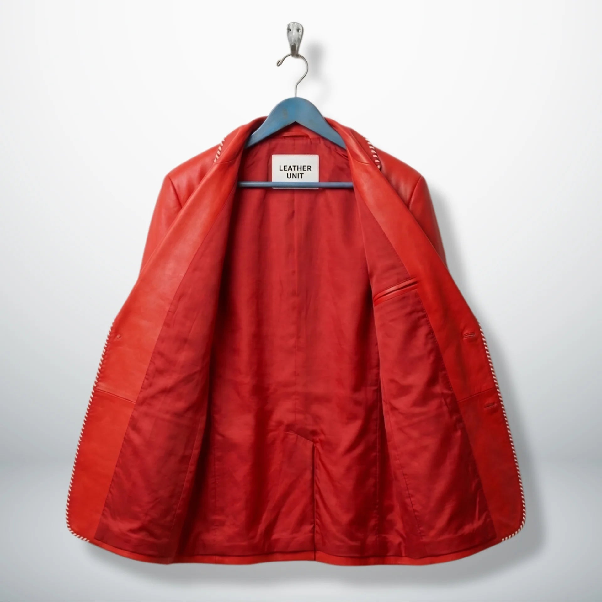 Inside lining of men’s red white striped leather blazer showing inner pockets