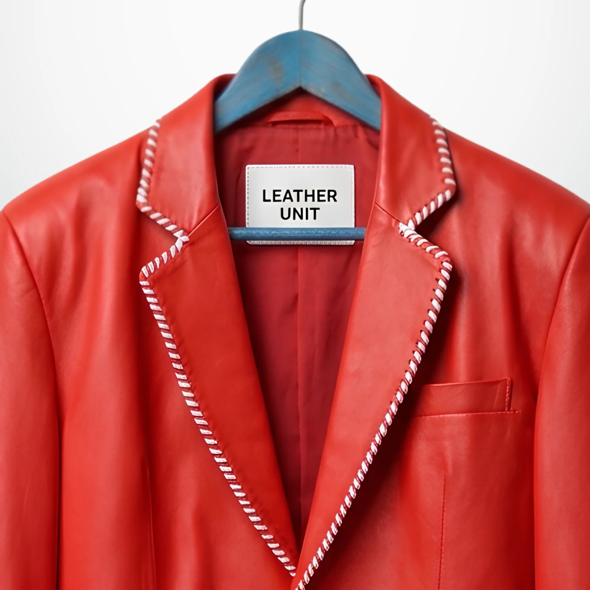 Close up of notch lapel and white striped edge on red leather blazer
