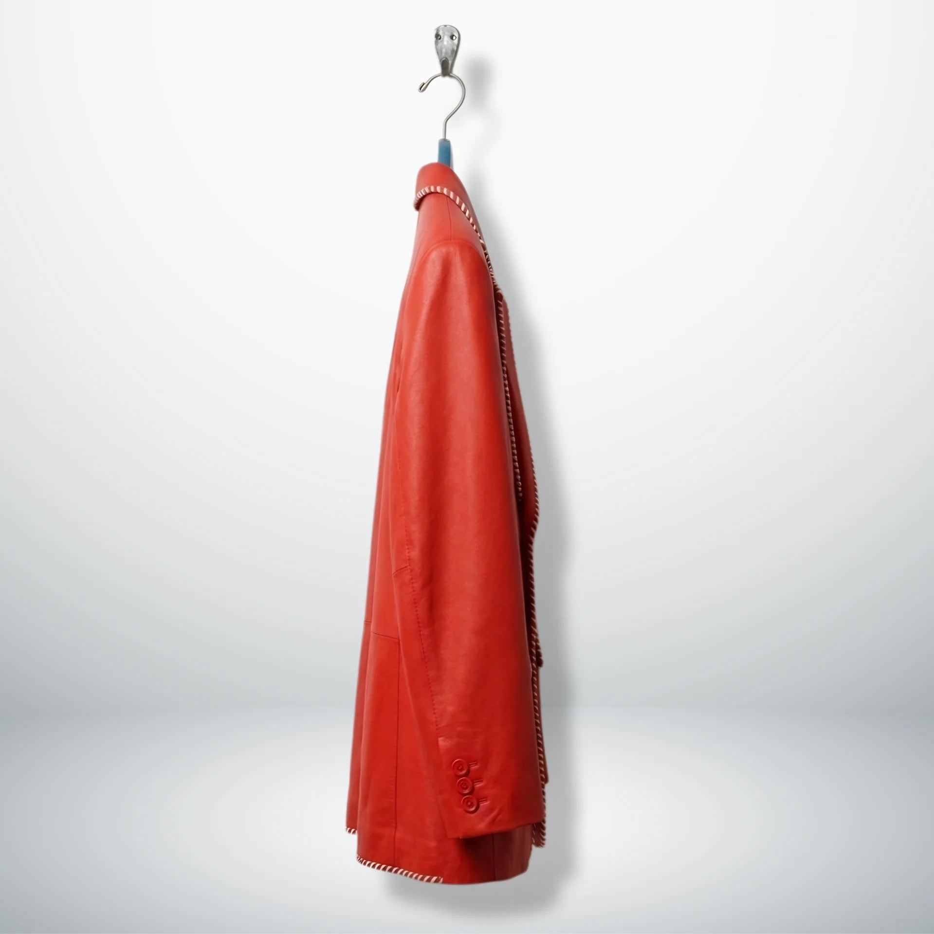 Side profile of men’s red leather blazer with two button closure