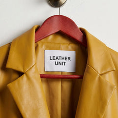 Close up of notched lapels and Leather Unit label on yellow leather blazer