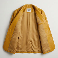 Inside lining of women’s yellow leather blazer showing interior pocket