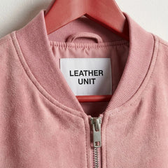 Close-up of ribbed collar and front zipper on pink suede leather bomber jacket