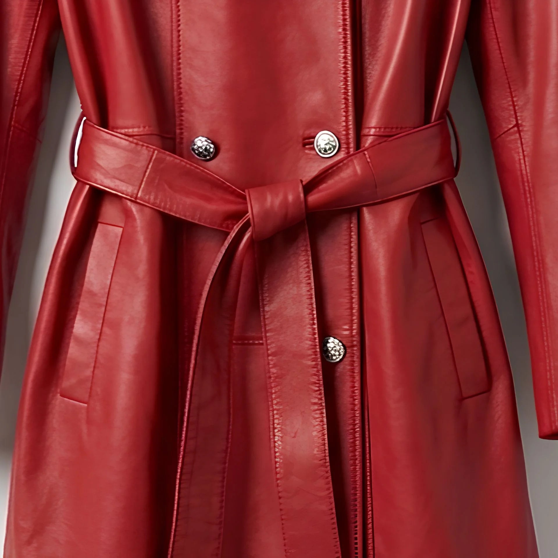 Belted waist and double breasted buttons on long red leather coat
