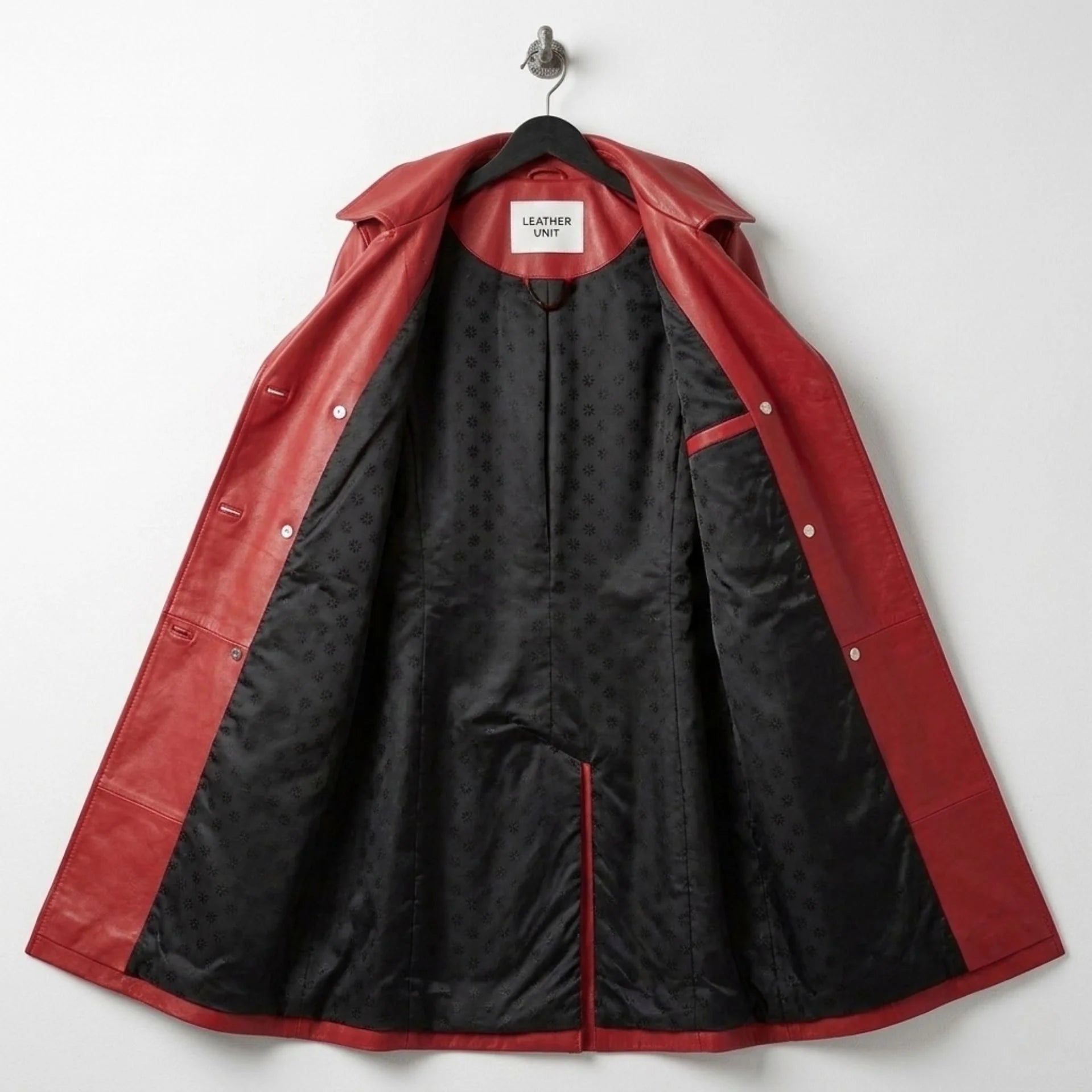 Inside lining of red leather trench coat showing black patterned interior