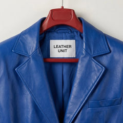Close up of notched lapels and Leather Unit label on blue leather blazer