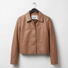 Women's tan cropped leather shirt jacket front view with shirt collar and button front