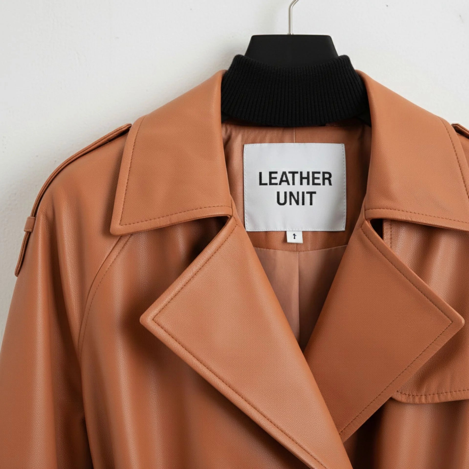 Close up of lapel collar and Leather Unit label on tan leather trench