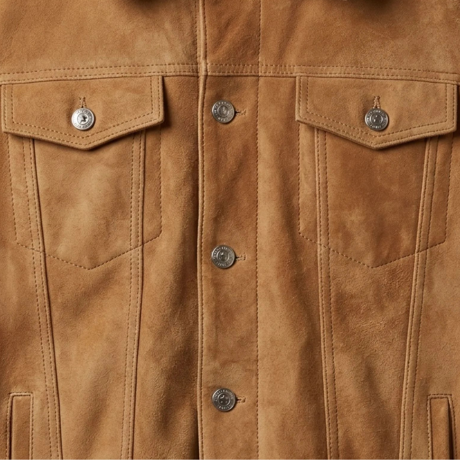 Chest flap pockets and metal button detail on men's tan suede trucker jacket