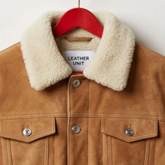 Close-up of faux shearling collar on men's tan suede trucker jacket by Leather Unit