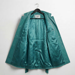 Interior lining of turquoise leather trench coat showing inner pocket