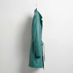 Side profile of mid‑length turquoise leather trench coat with belt
