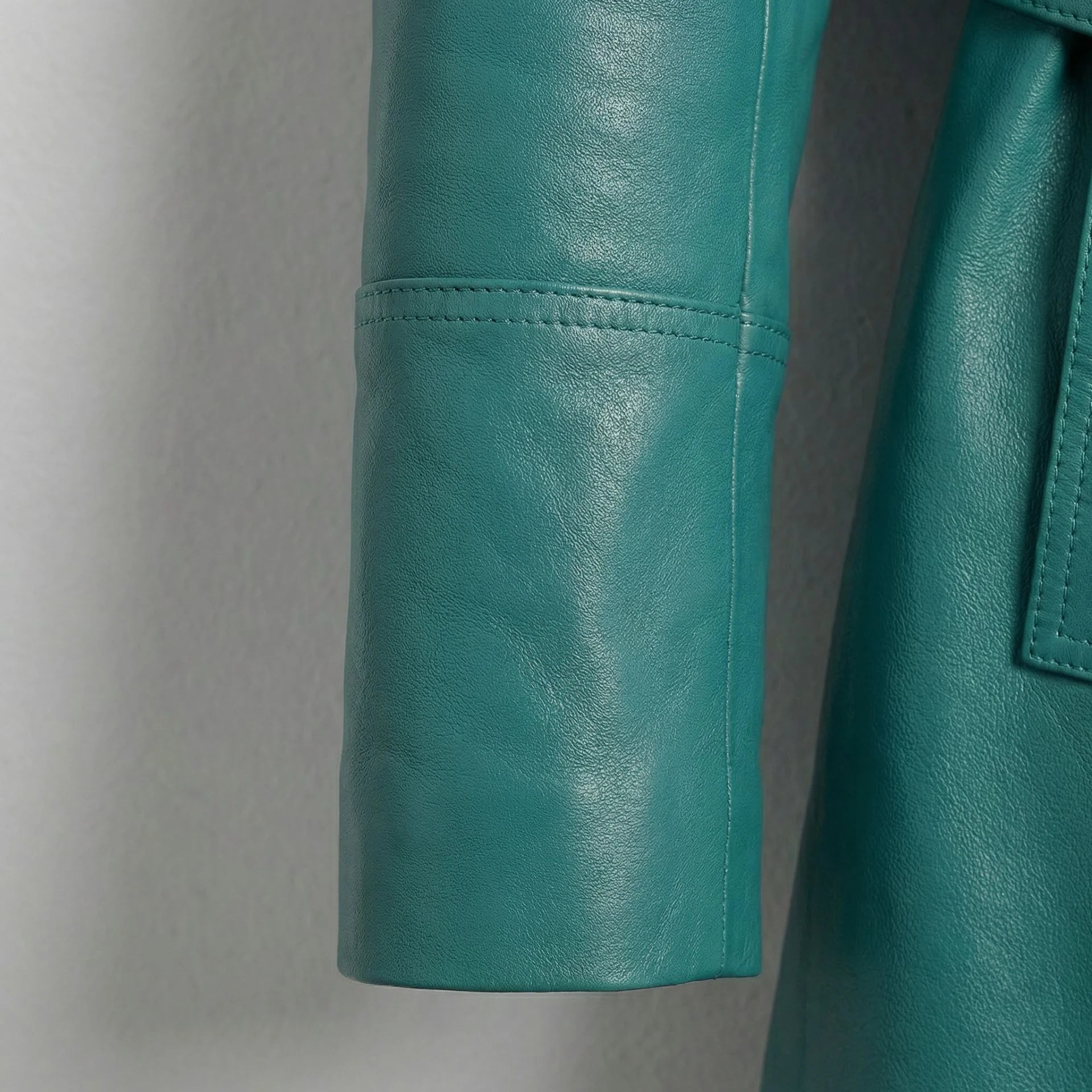 Sleeve detail on smooth turquoise lambskin leather coat