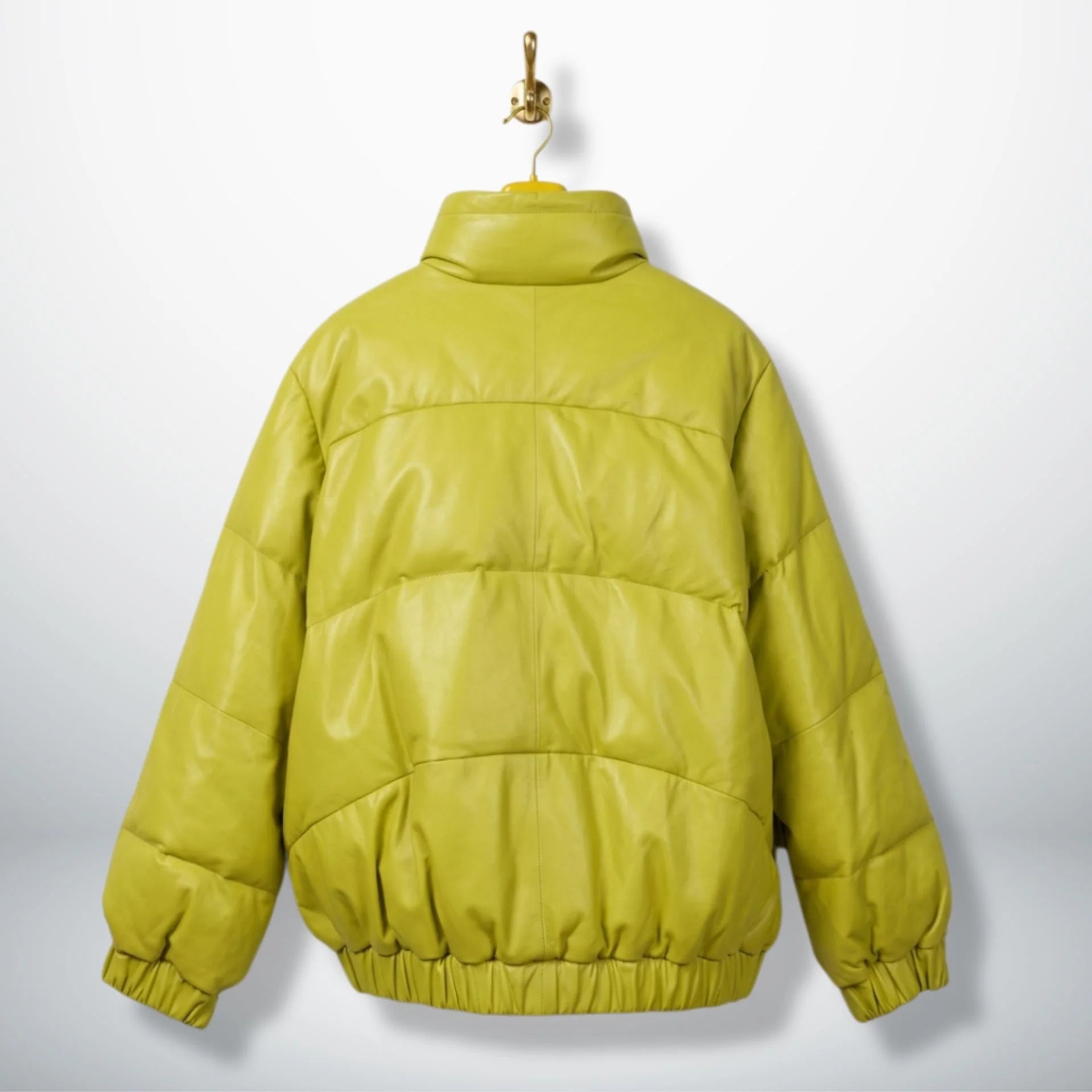 Back view of unisex neon lime leather puffer jacket with elastic hem