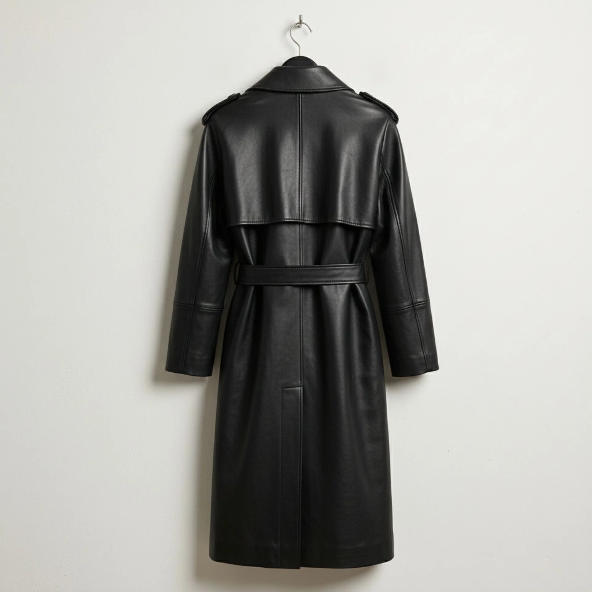 Back view of belted black leather trench coat with storm flap