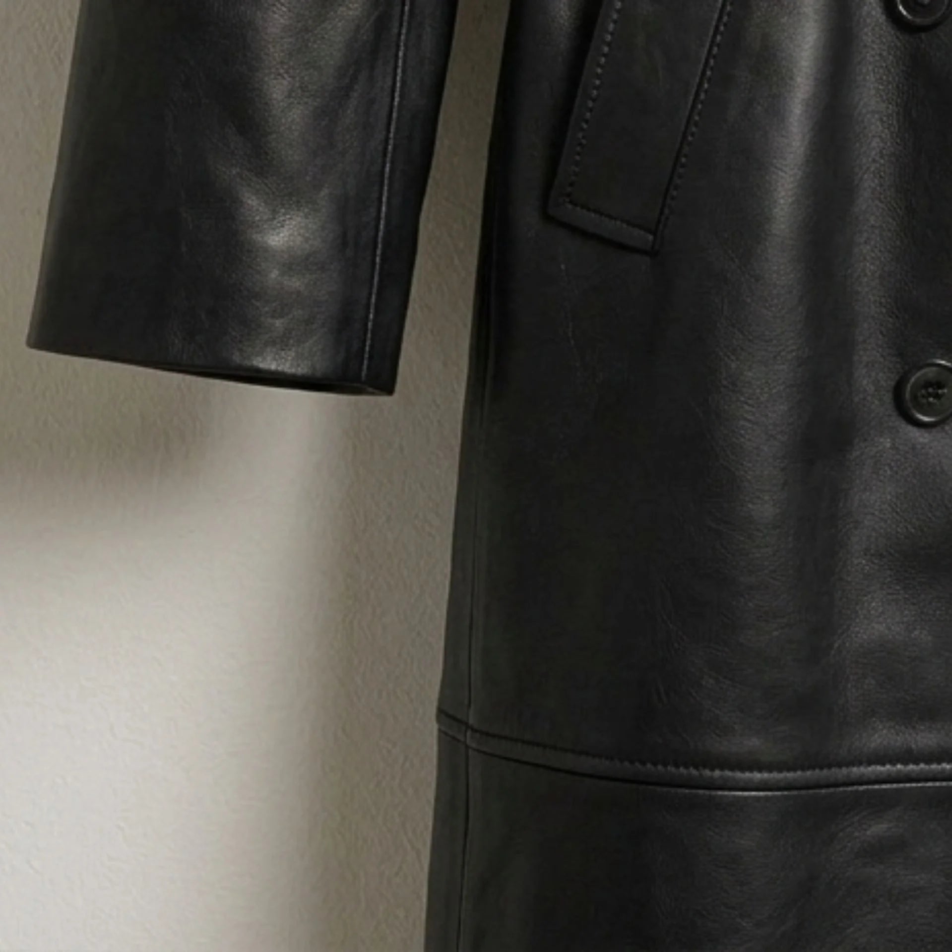 Sleeve and stitching detail on women’s genuine black leather trench coat