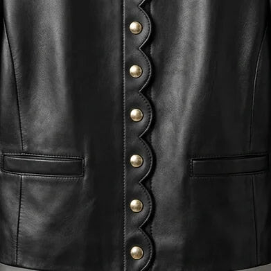 Close up of scallop edge front and gold buttons on women’s black leather blazer