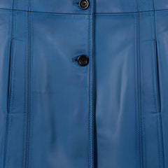 Front buttons and welt pocket detail on women’s blue waxed leather coat