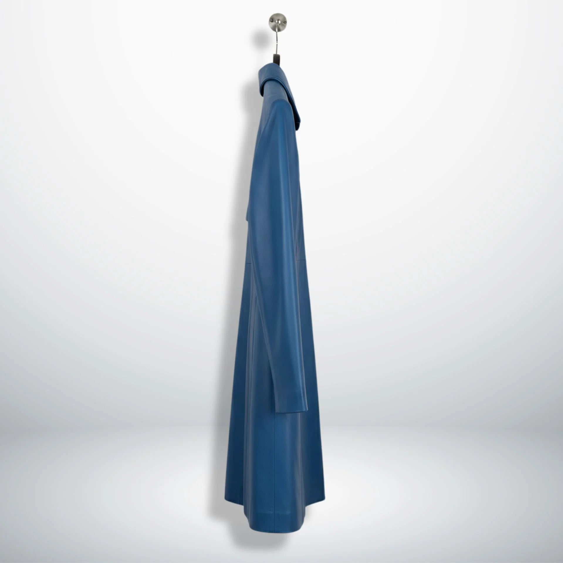 Side profile of mid‑thigh women’s blue leather coat showing slim fit