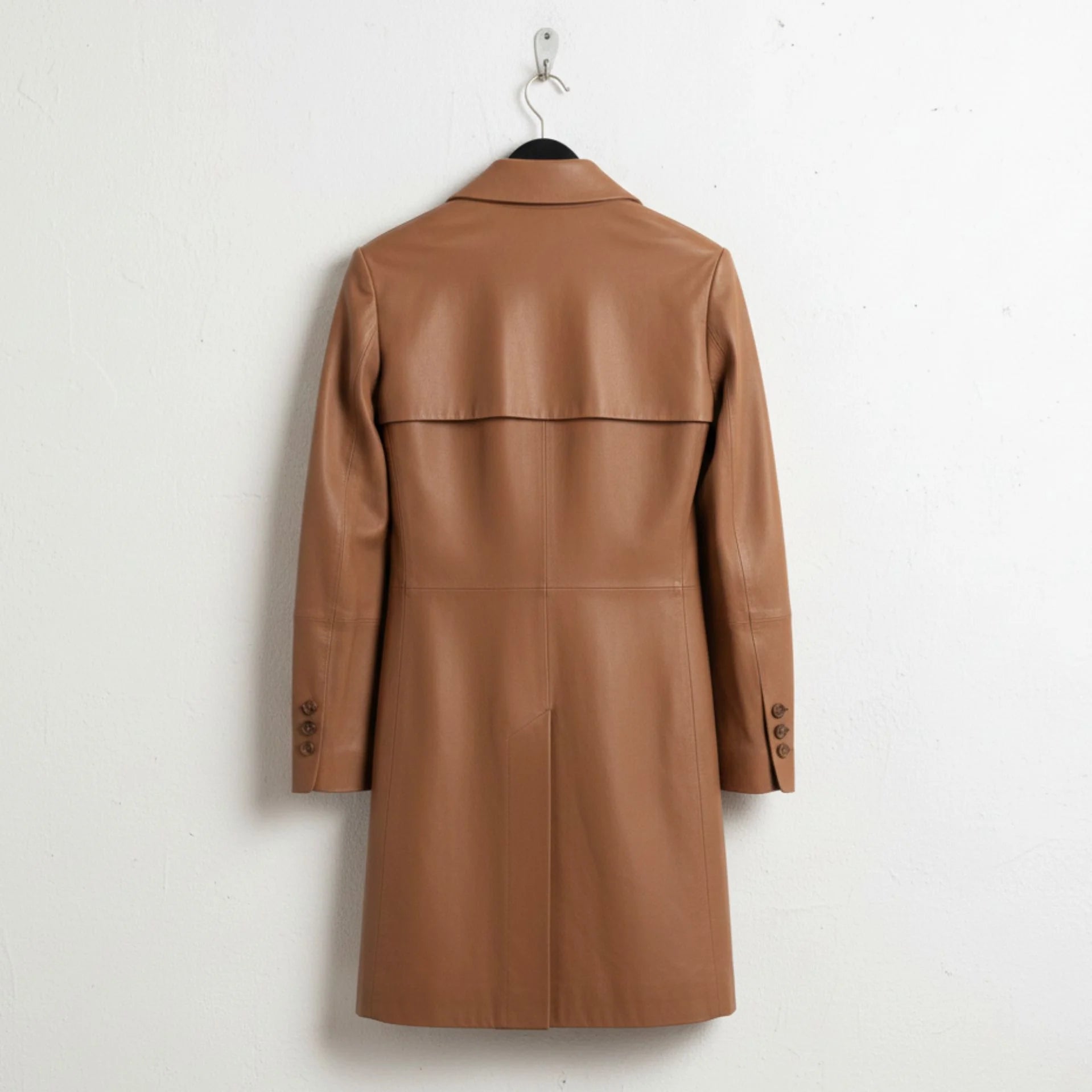 Back view of women’s brown leather long coat with storm flap and vent
