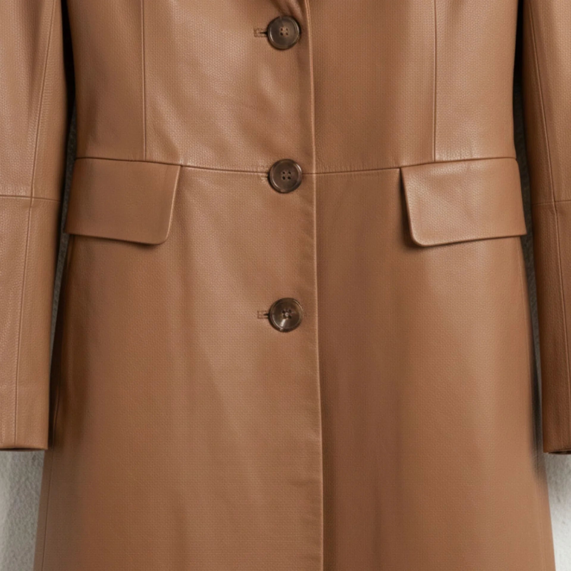 Front buttons and flap pockets on women’s brown real leather long coat