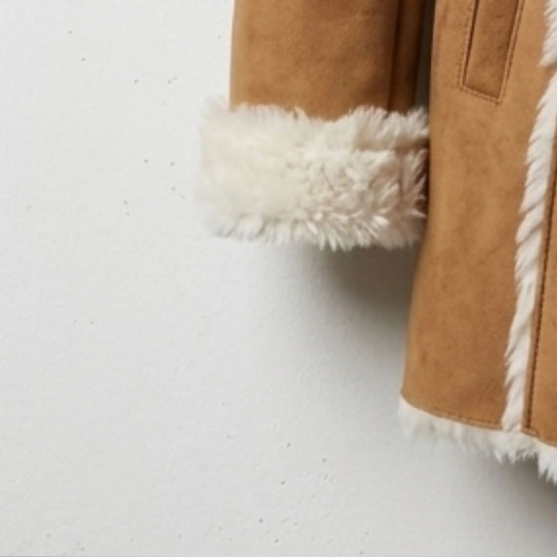 Shearling cuff and sleeve detail on women’s camel suede hooded coat
