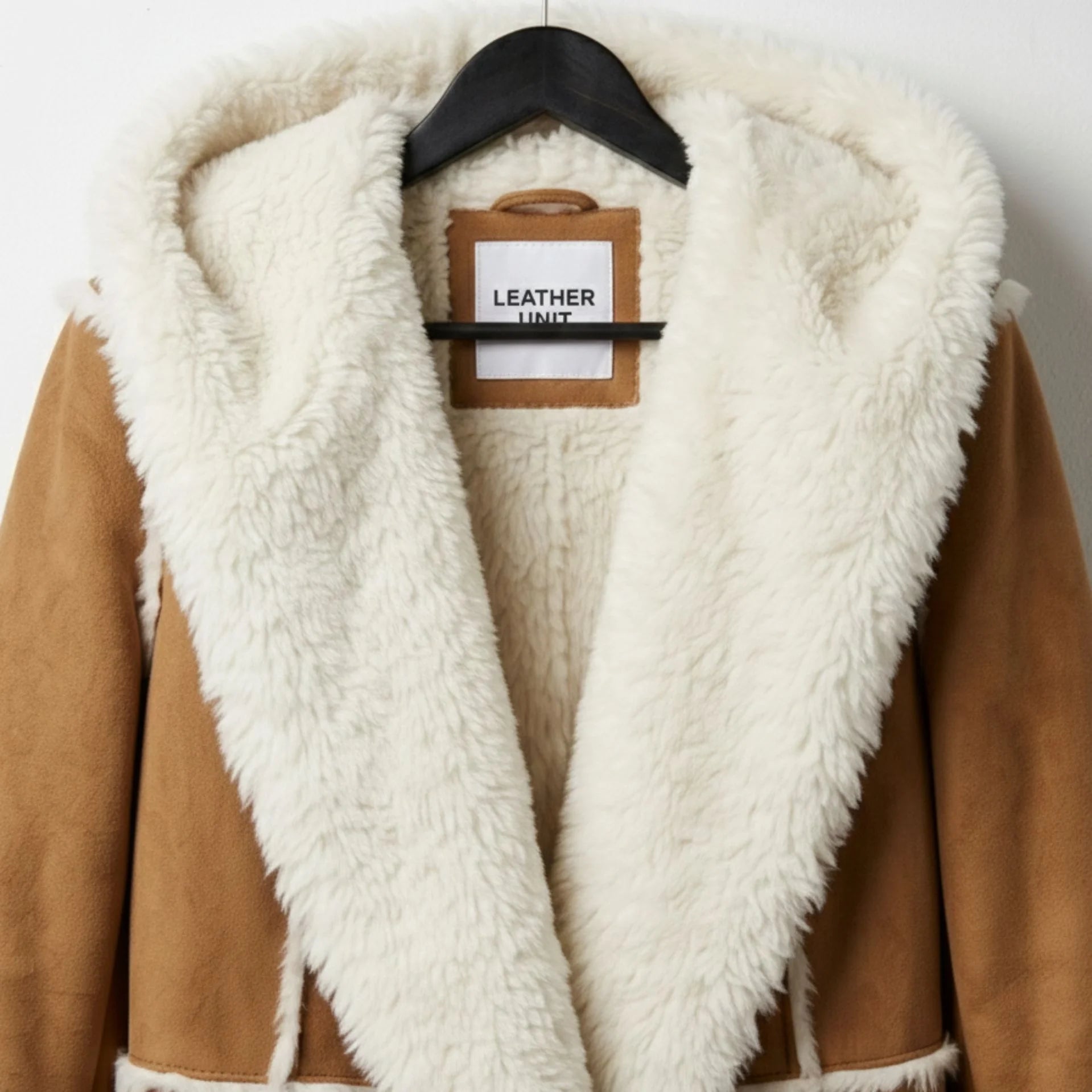 Close up of hood and shawl collar shearling trim on women’s suede coat