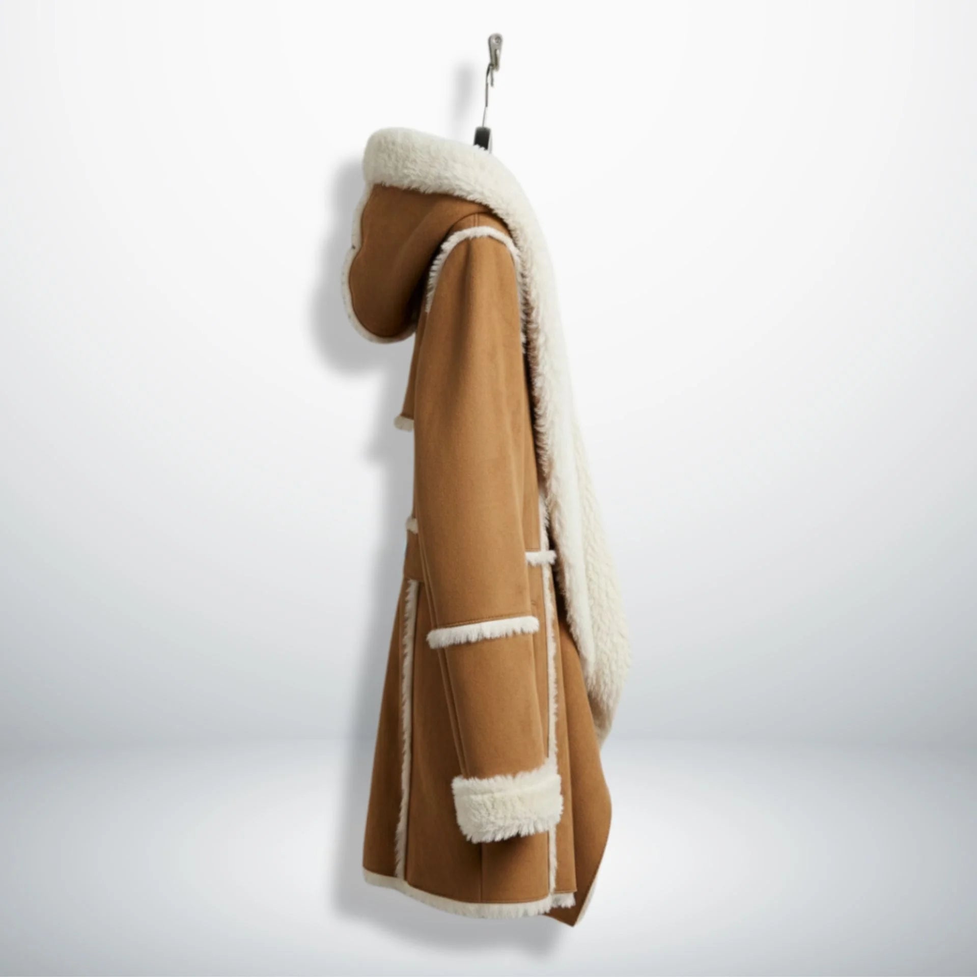 Side profile of mid‑thigh brown suede shearling coat with hood