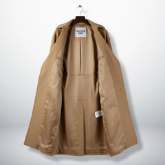 Inside lining of women’s camel wool trench coat showing full interior