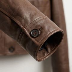 Close up of button cuff on women’s dark brown lambskin leather jacket