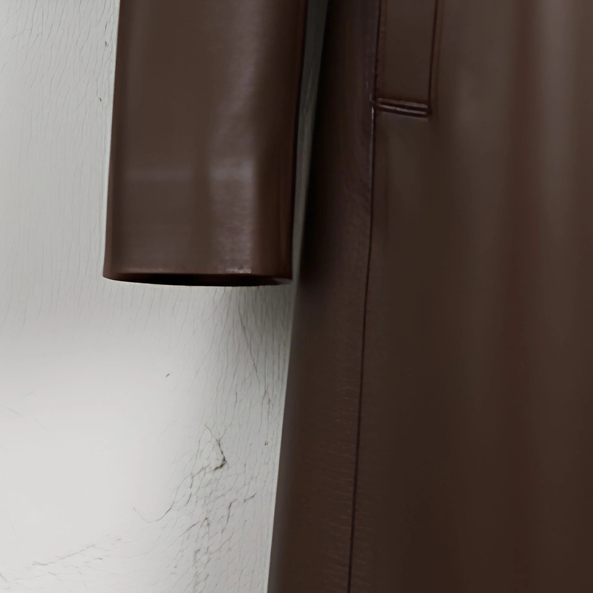 Sleeve detail and smooth finish on women’s deep brown leather coat