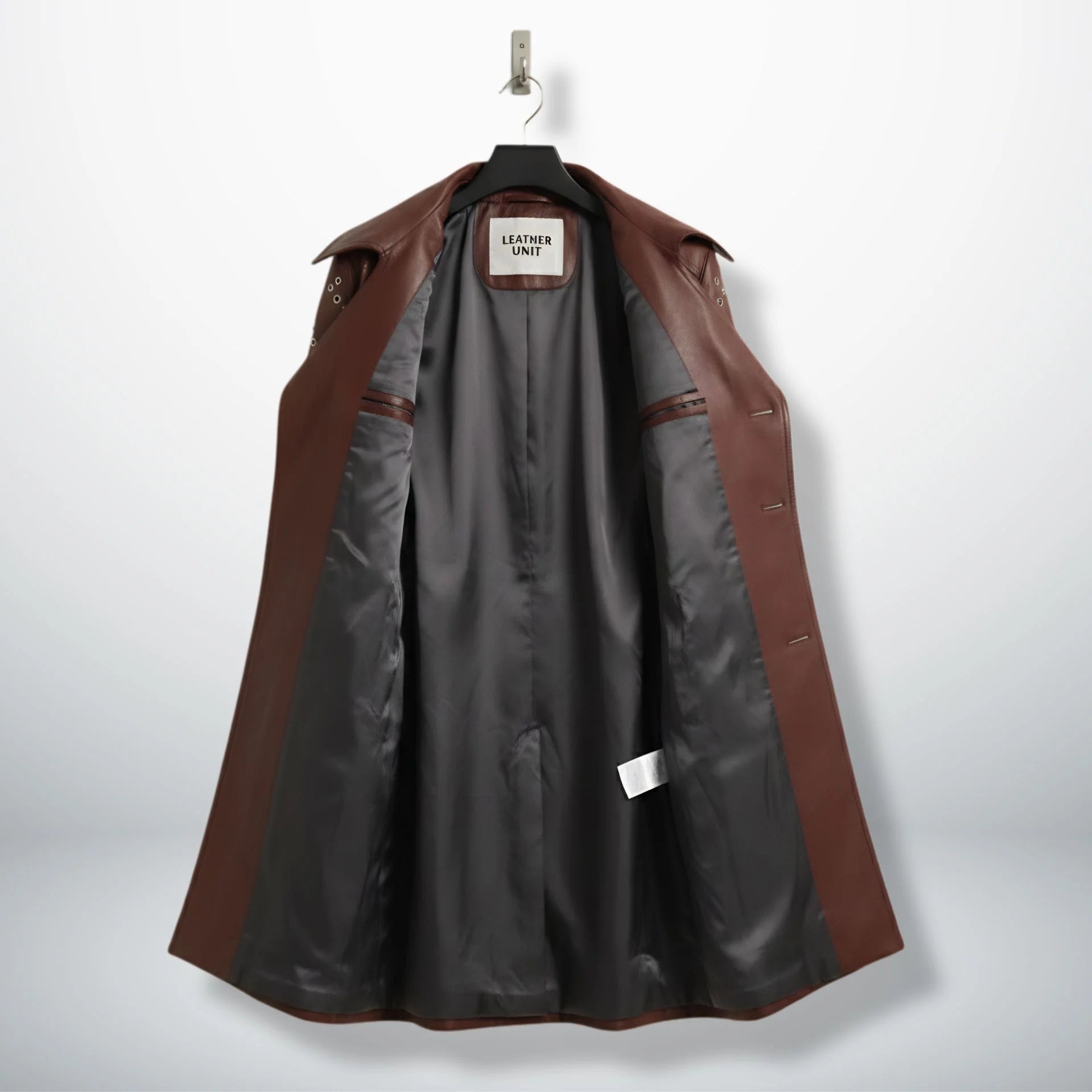 Inside lining of women’s maroon leather trench coat showing dark interior