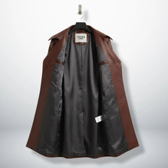 Inside lining of women’s maroon leather trench coat showing dark interior