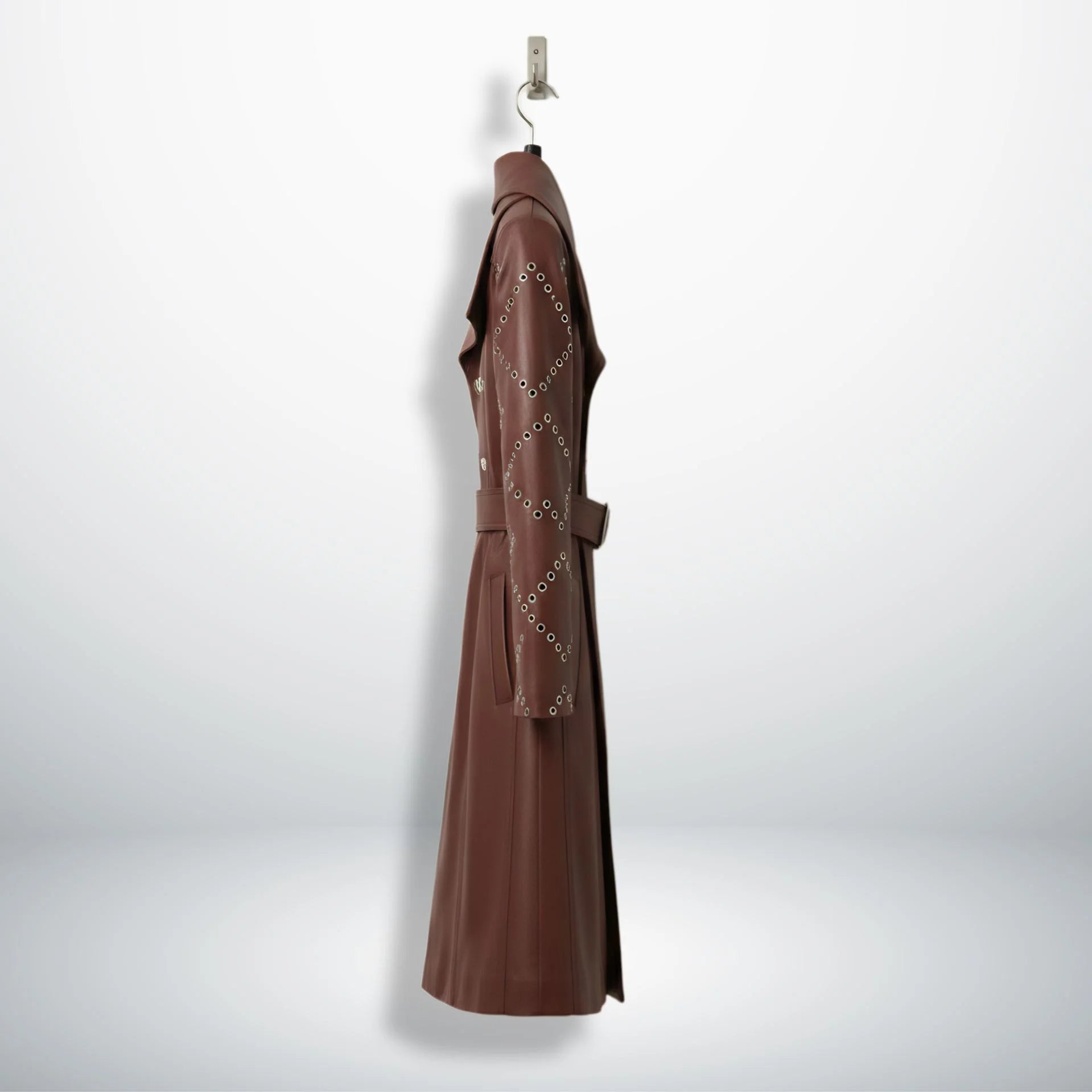 Side profile of long maroon leather trench coat for women