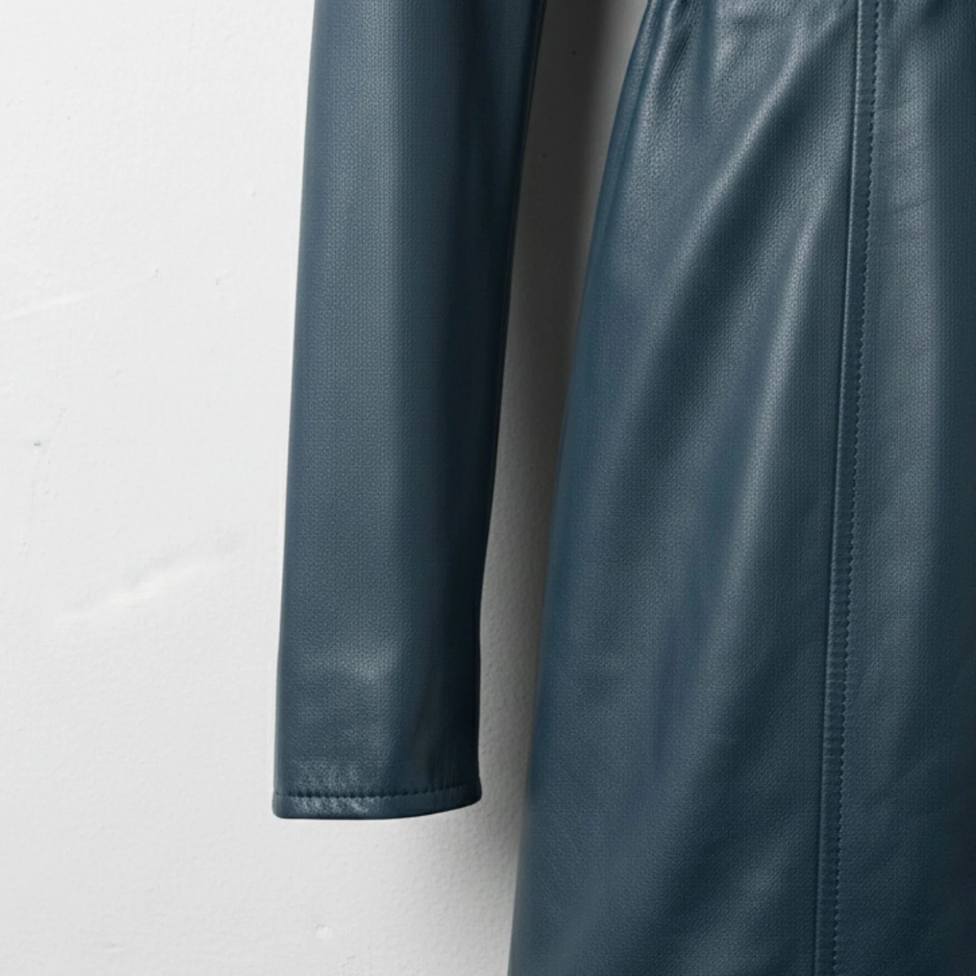 Sleeve and seam detail on women’s navy lambskin leather coat