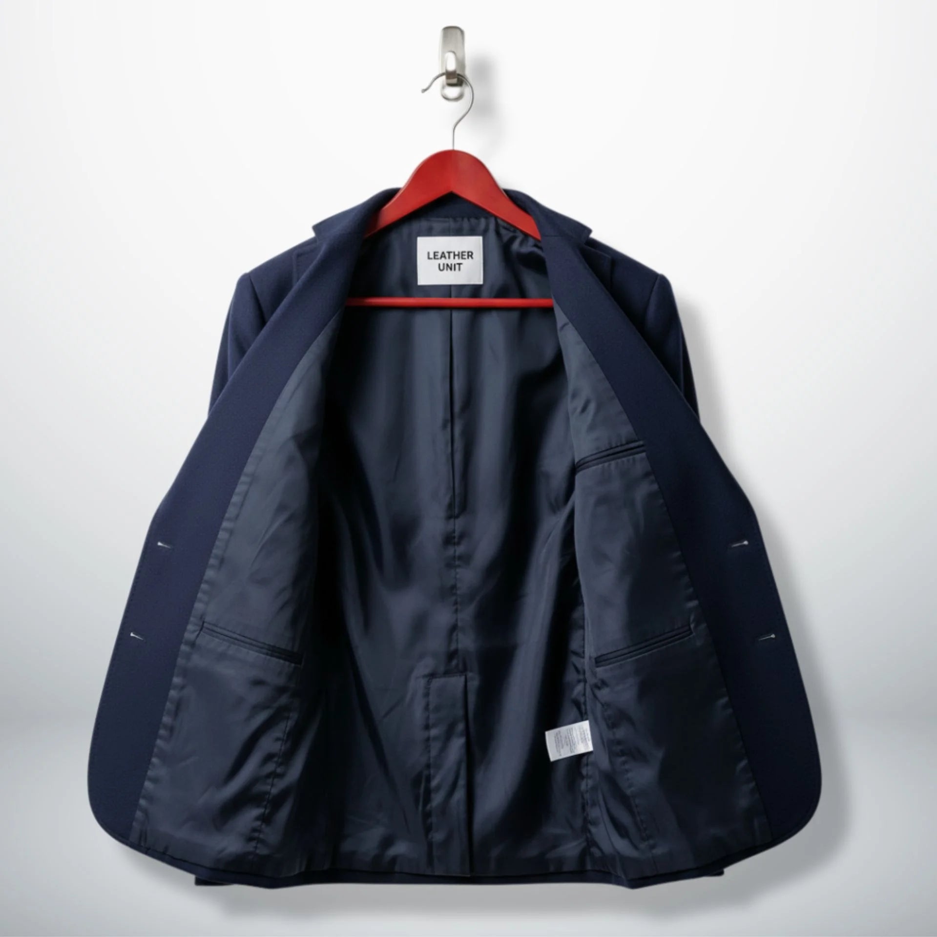 Inside lining of women’s navy blue wool blazer showing inner pockets