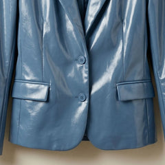 Two button front and flap pockets on women’s sapphire blue leather blazer