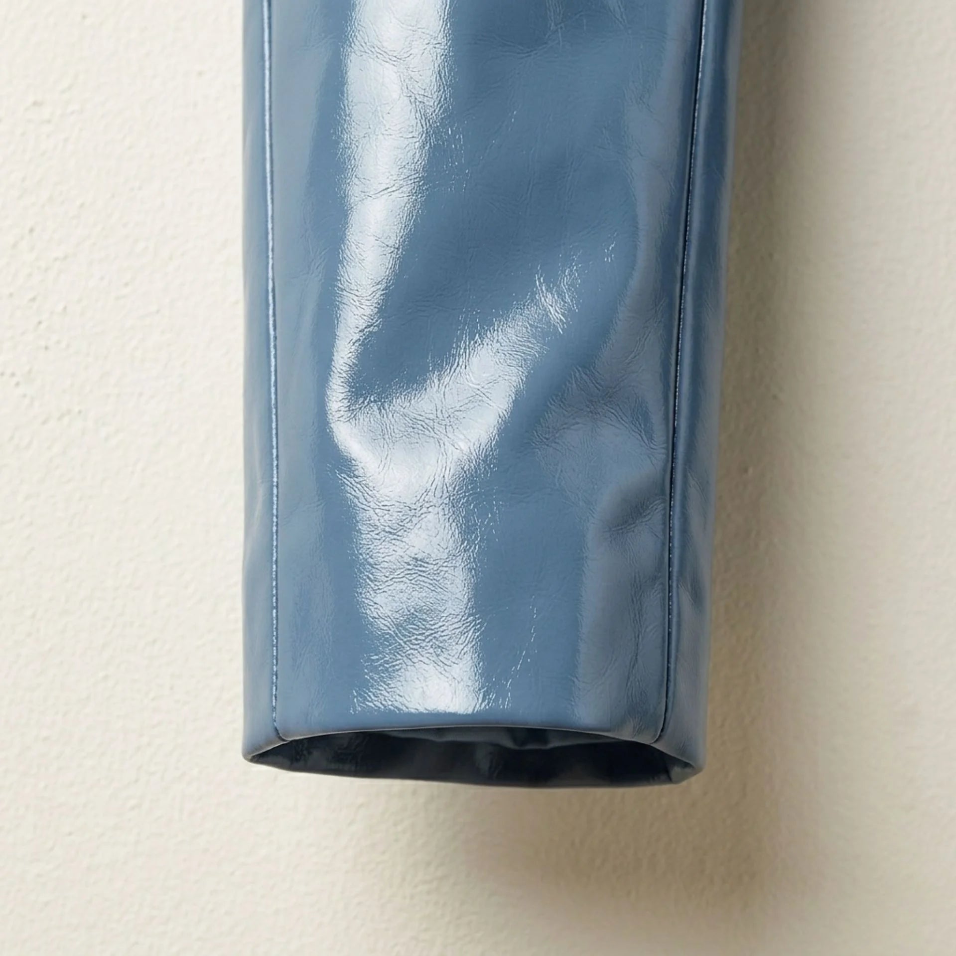 Sleeve and cuff detail on women’s glossy sapphire blue leather blazer