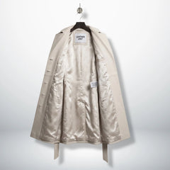Inside satin lining of women’s silver leather trench coat