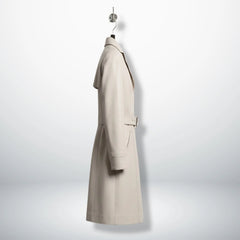 Side profile of knee length white leather trench coat for women