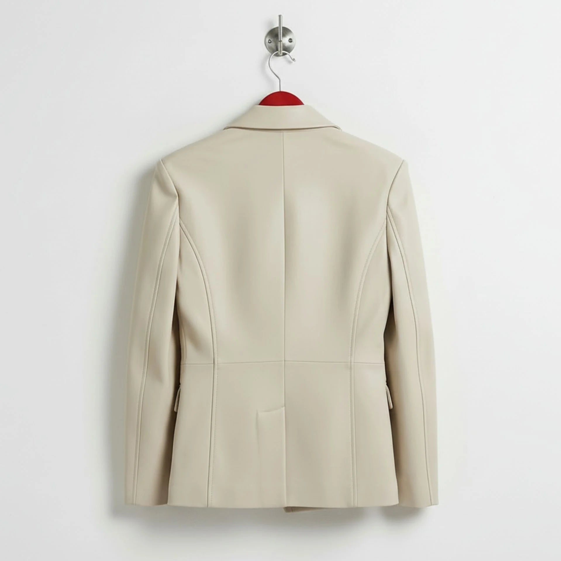 Back view of tailored women’s white leather blazer