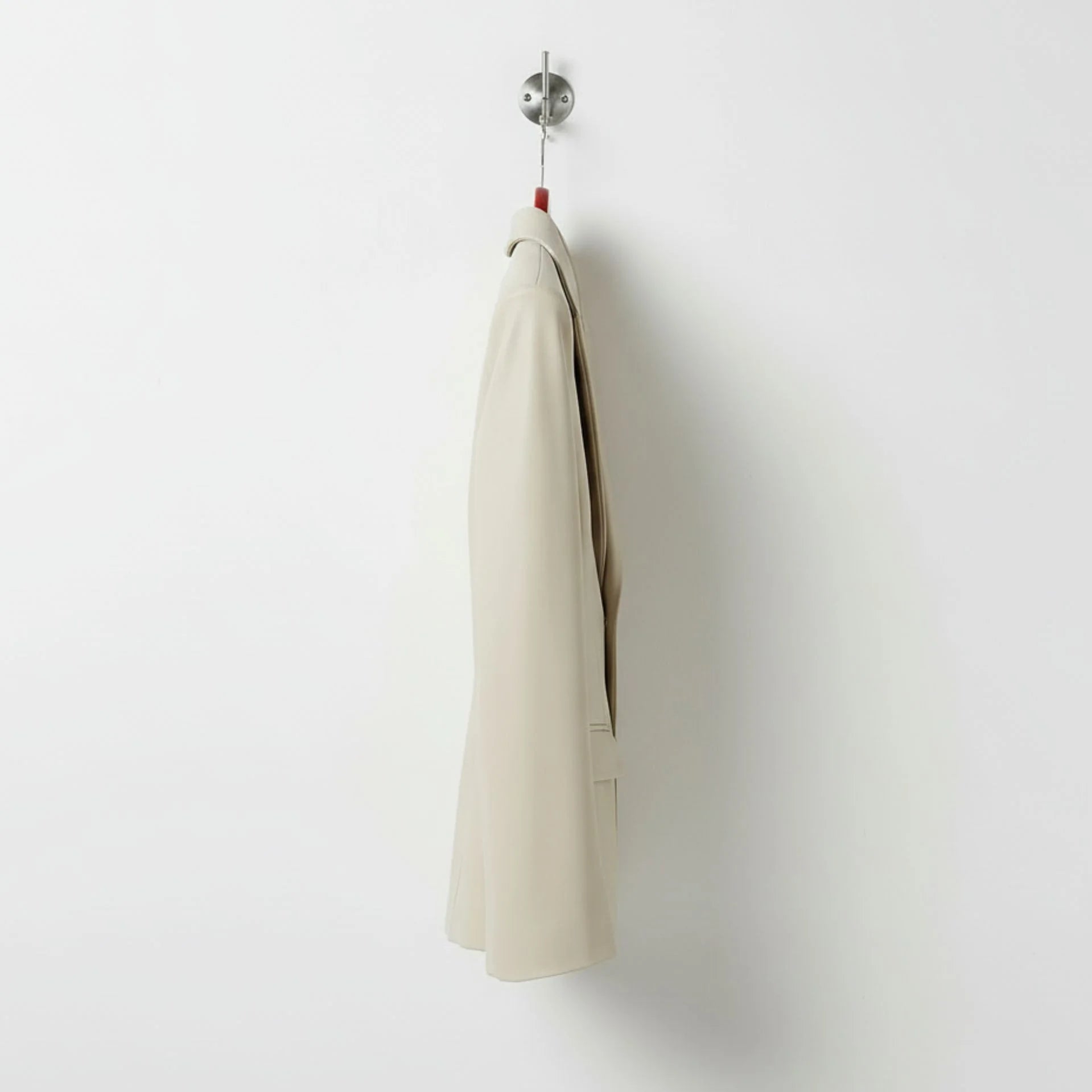 Side profile of hip length women’s white leather blazer