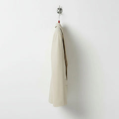 Side profile of hip length women’s white leather blazer