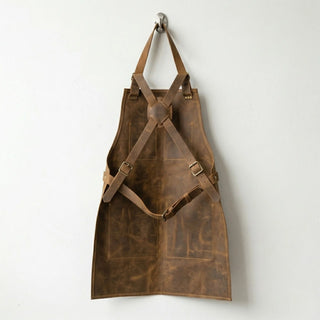 Back view of brown leather shop apron showing cross back straps